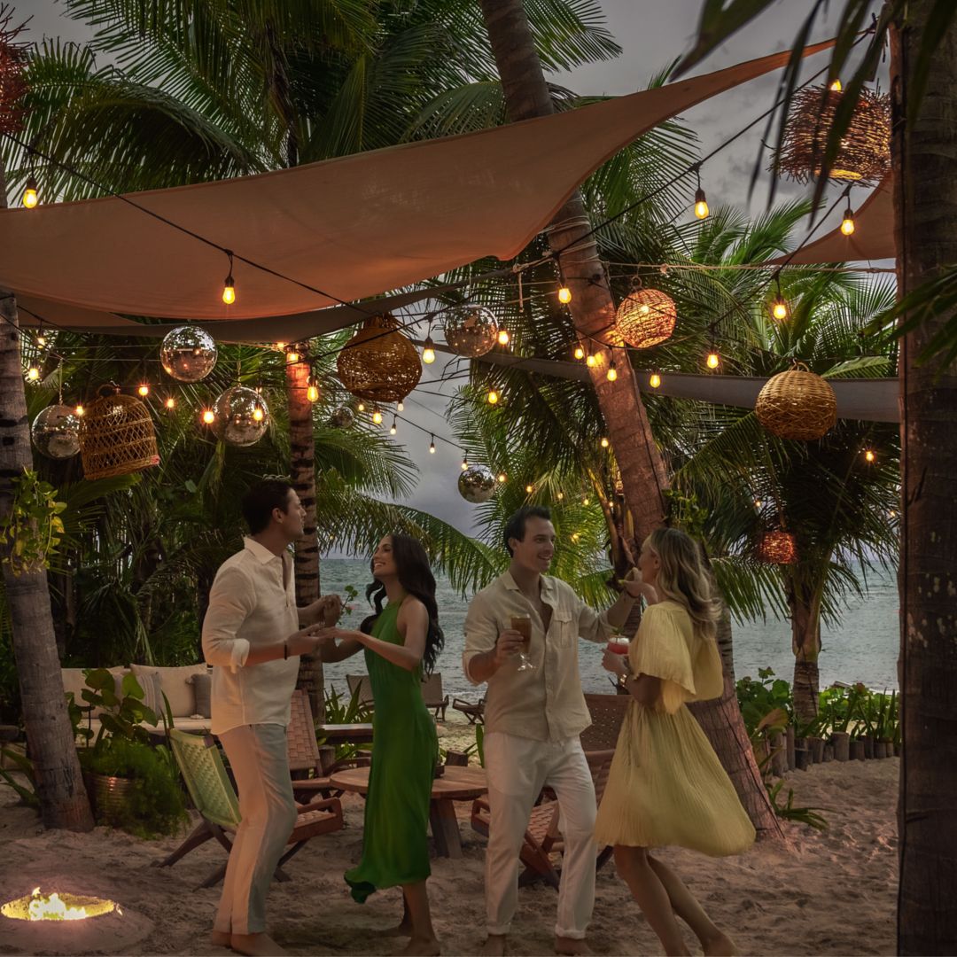 Group of friends dancing at the Full Moon Party at La Cantina