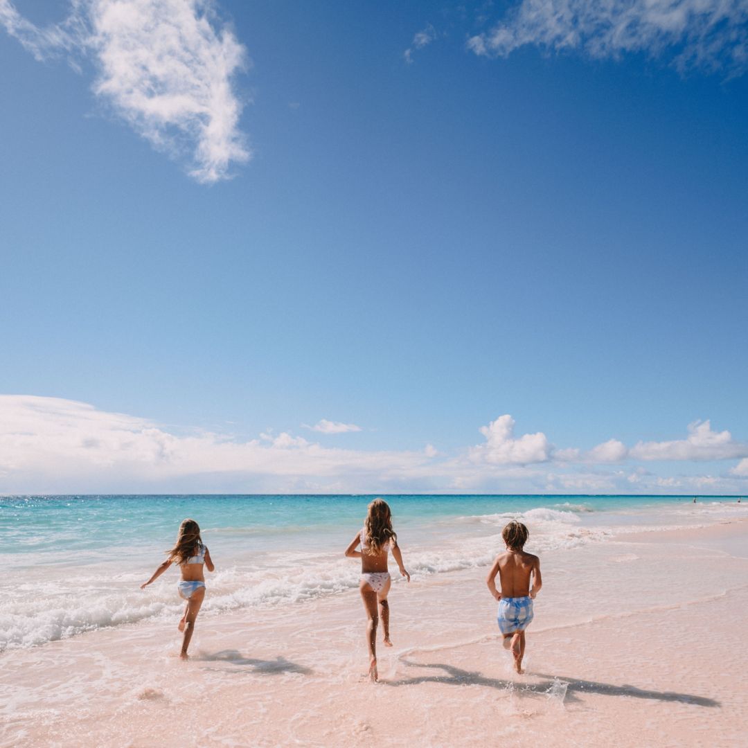 Children running and playing on the beach