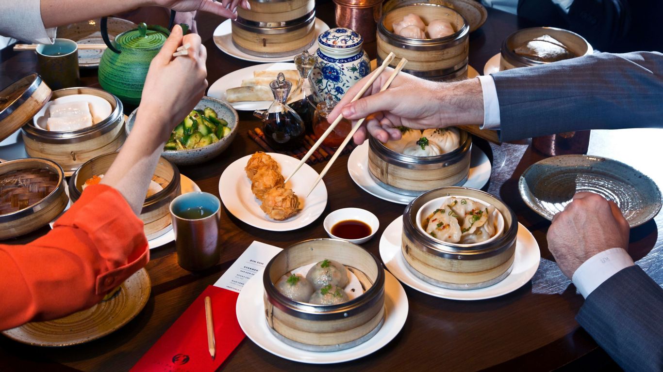A vibrant scene of a Yum Cha Gala during the Mid-Autumn Festival, showcasing a variety of delicious dim sum dishes and a festive atmosphere filled with laughter and joy