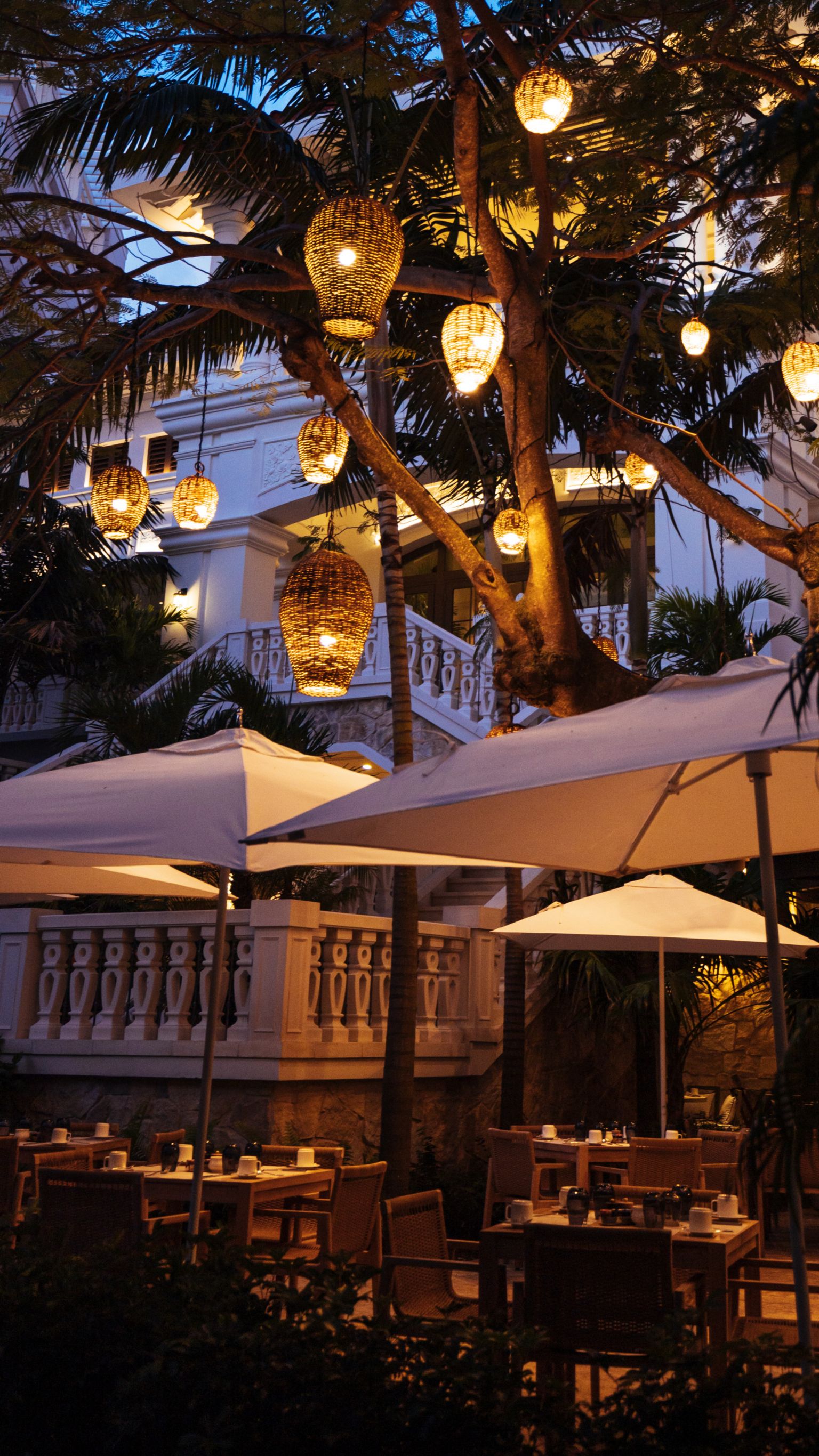 Cafe Boulud terrace at night with lanterns on