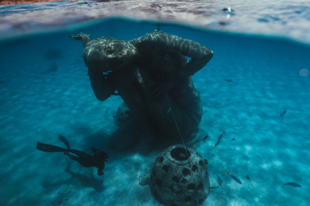 view of ocean atlas statue from above and below water