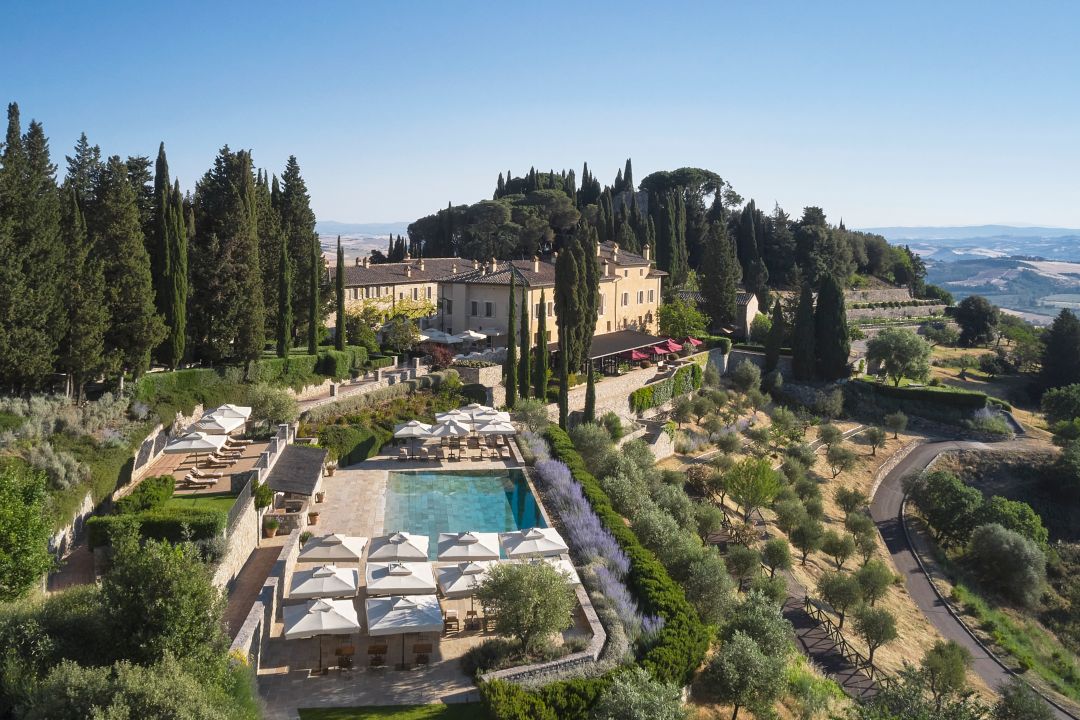Tuscan luxury hotel in Italy surrounded by cypress trees, terraced gardens and a guest pool