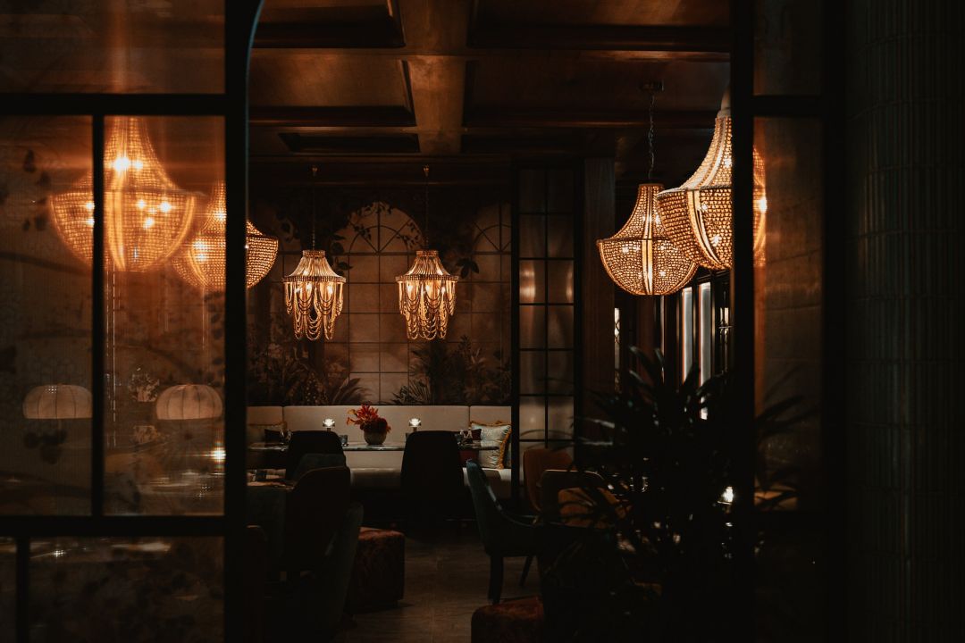 Ducks roast slowly in a wood-burning oven, their exteriors caramelizing to crackling perfection. Nearby, one chef twists and stretches dough by hand to form noodles, while another creates dim sum with intricate folds and delicate fillings. This is Koo Madame, where an all-Chinese team breathes authentic new life into ancient traditions, from the elegant rituals of the Gongfu Cha tea ceremony to the earthy mellowness of the bamboo-aged cocktails. With Art Deco–inspired interiors that evoke Shanghai of the 1920s, the setting is as glamorous as its namesake, society hostess and fashion icon Madame Wellington Koo. 