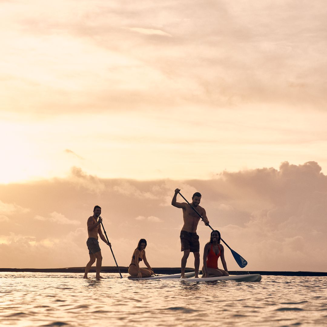 Paddleboarding at sunset at summer at Rosewood Mayakoba