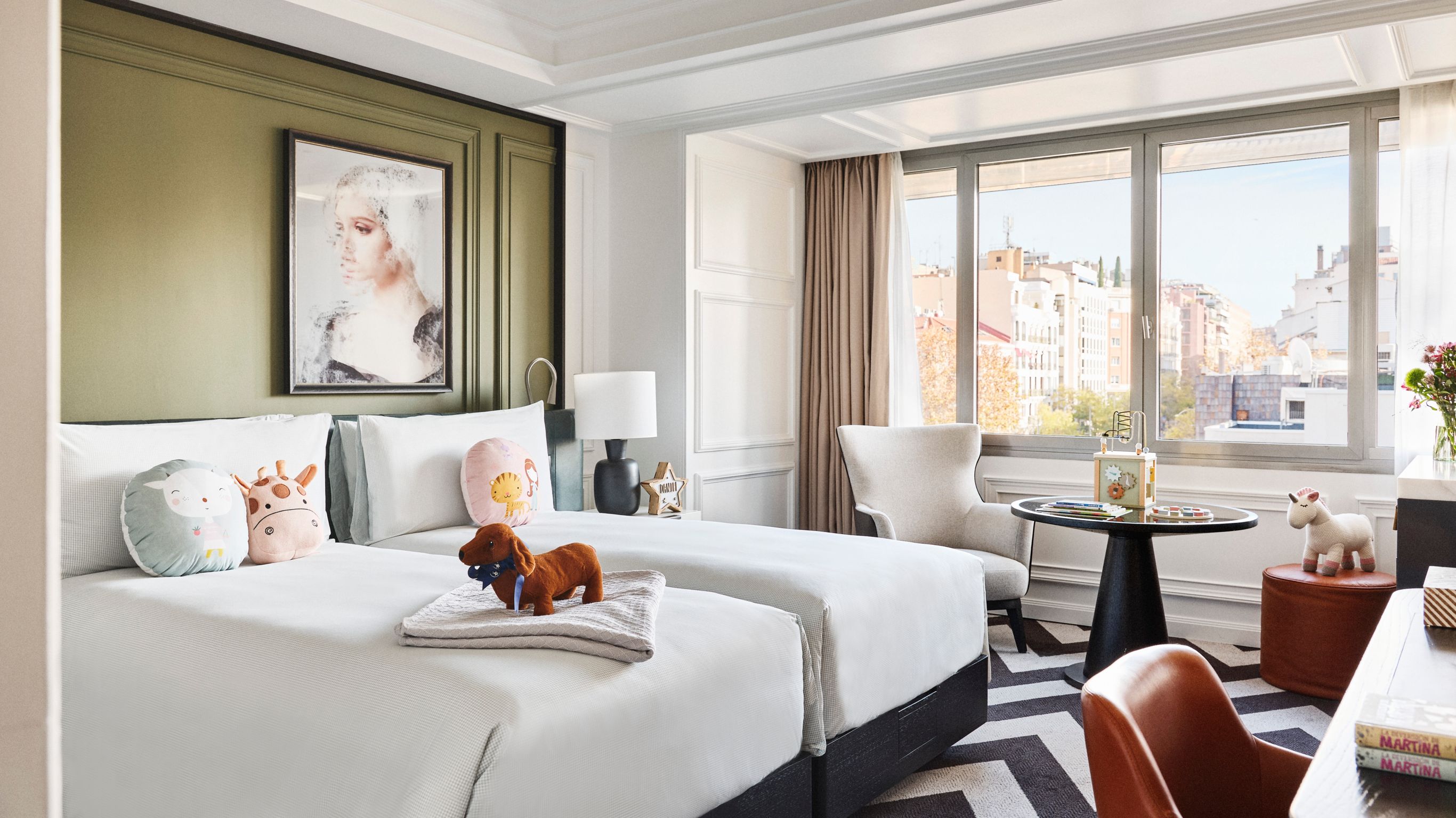 interior of the One Bedroom Suite showing a king bed with white sheets and grey painted walls at a hotel in Madrid