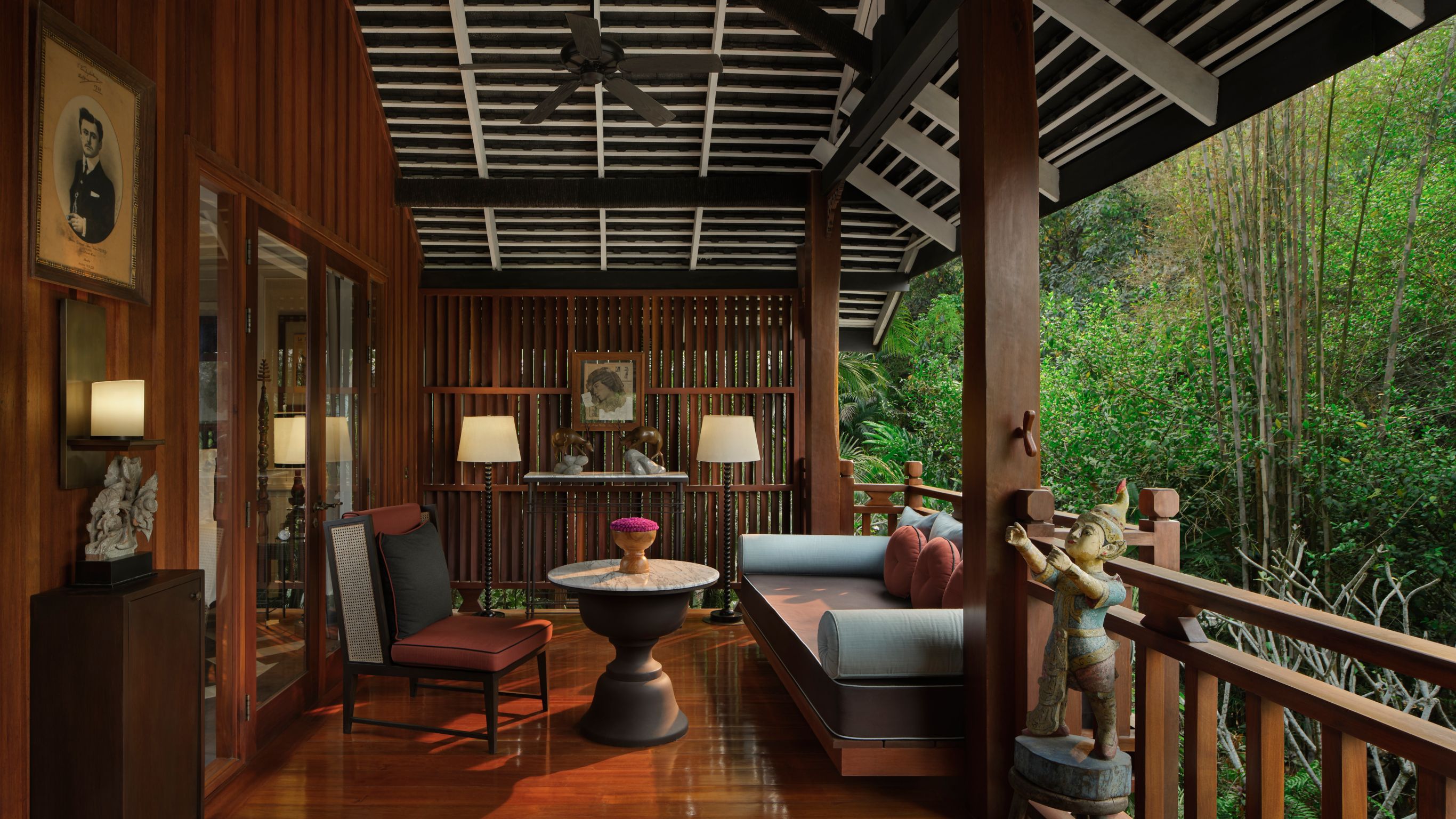 Balcony of a luxury resort residence featuring a lounge sofa, round table, and chair in Luang Prabang