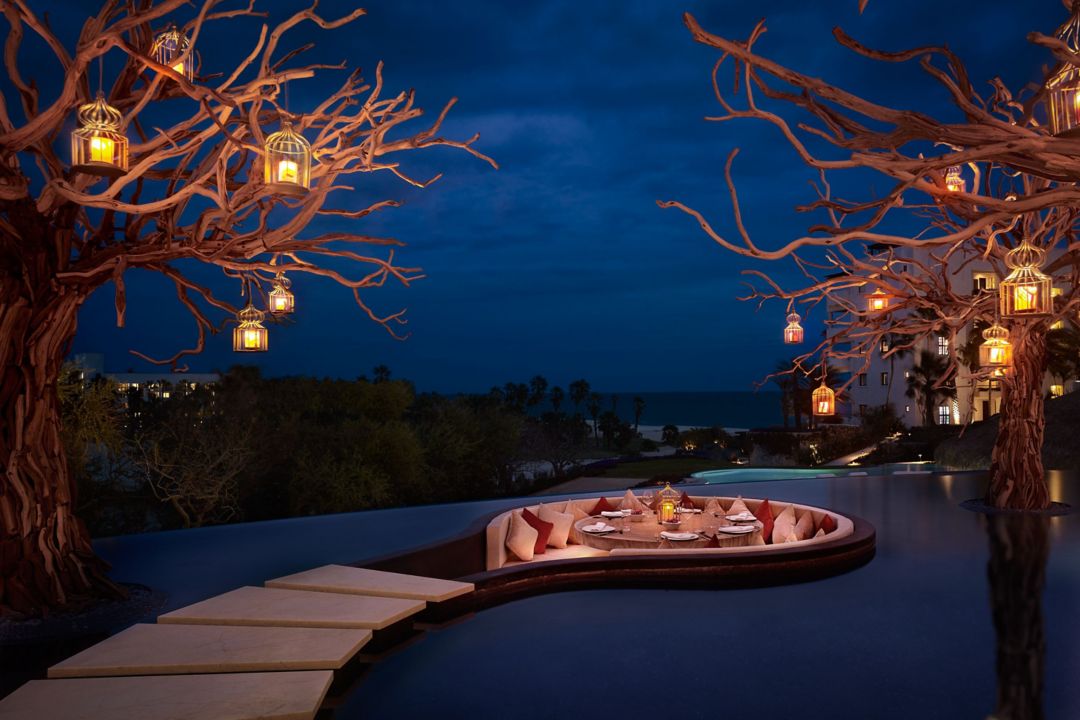 An Indian restaurant in Cabo with arched ceilings, warm lighting, and tables set for dining.