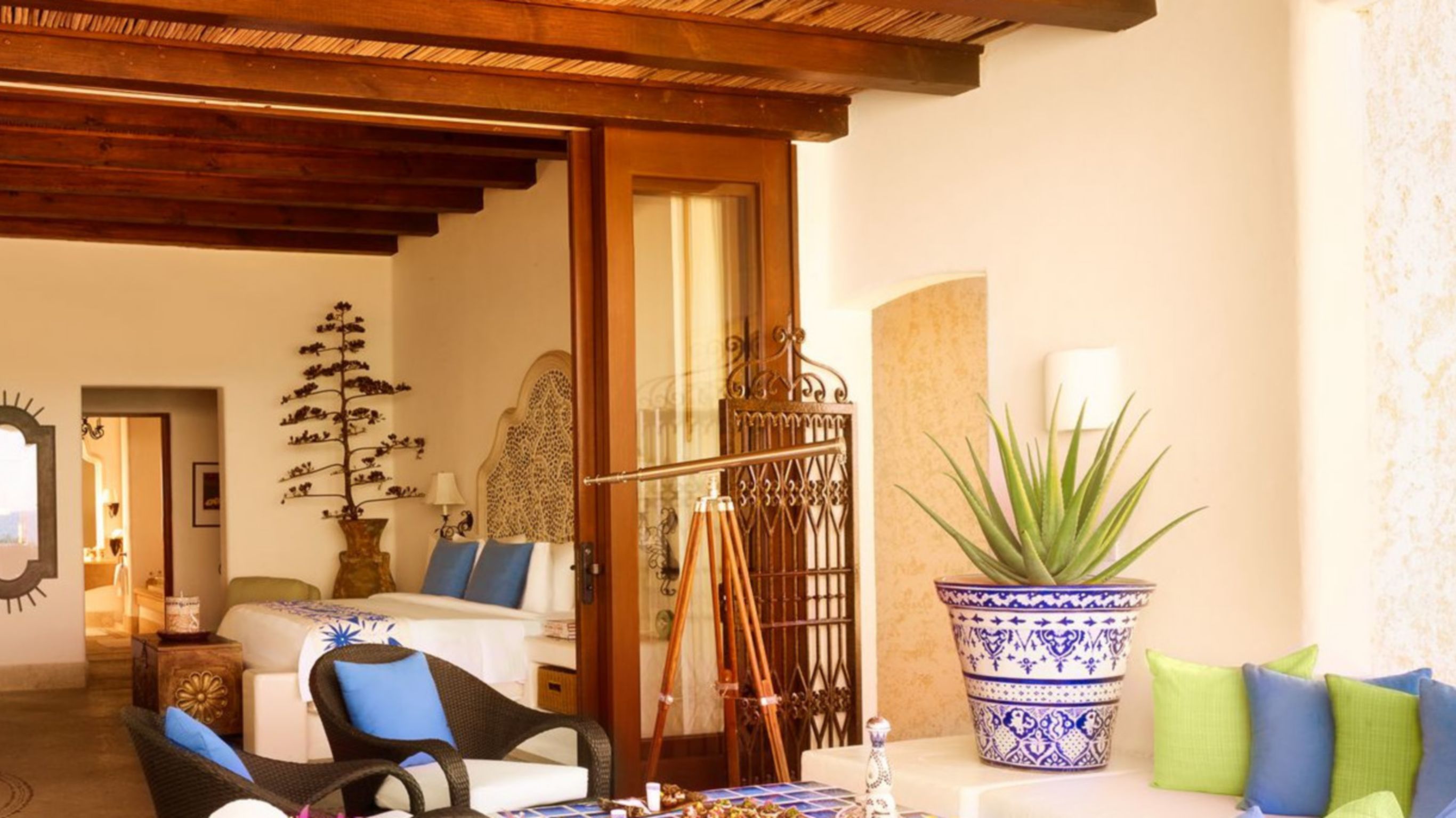 A luxury villa with a living area, bedroom and a private pool overlooking the ocean.