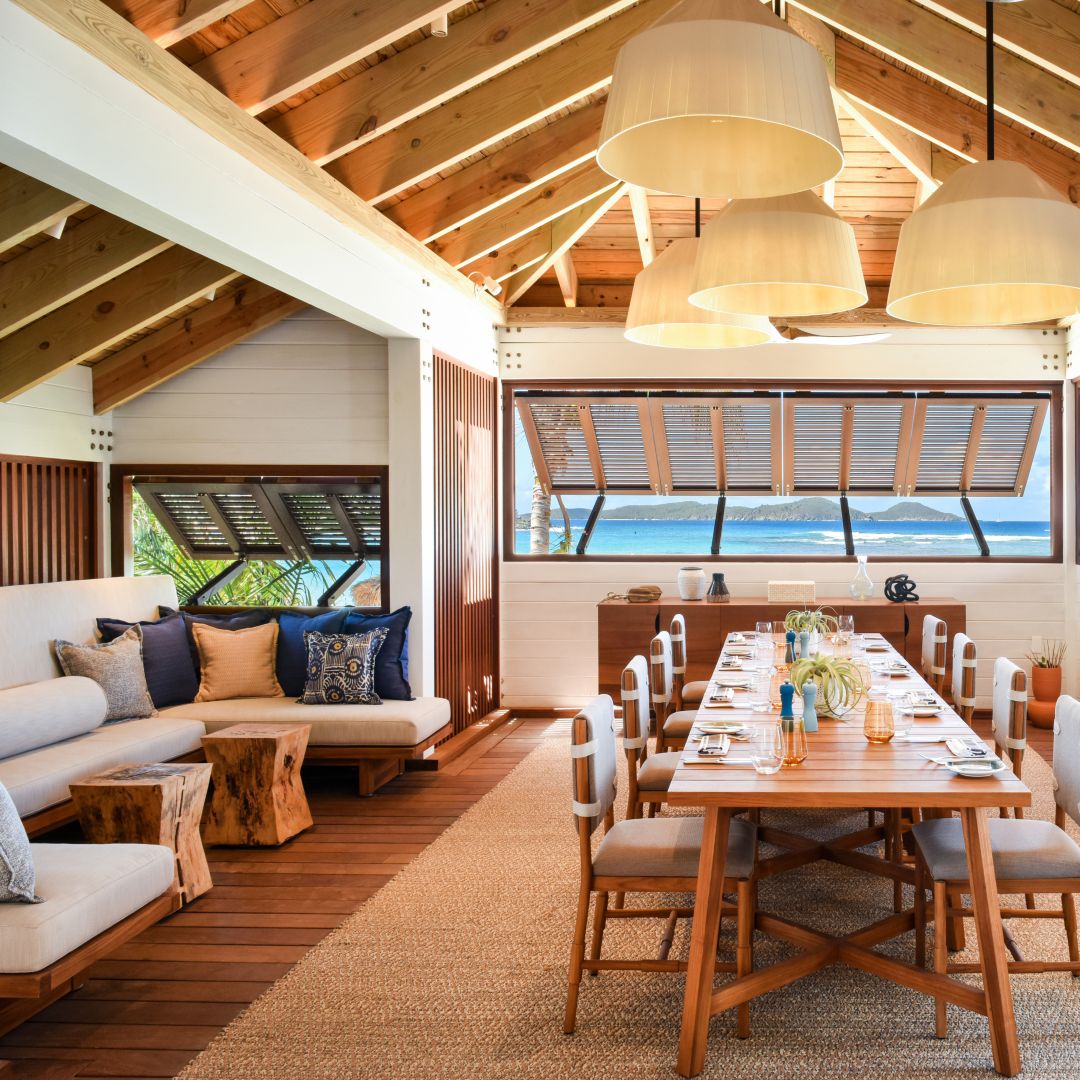 Private dining room with ocean views, a set  table, and a sofa.