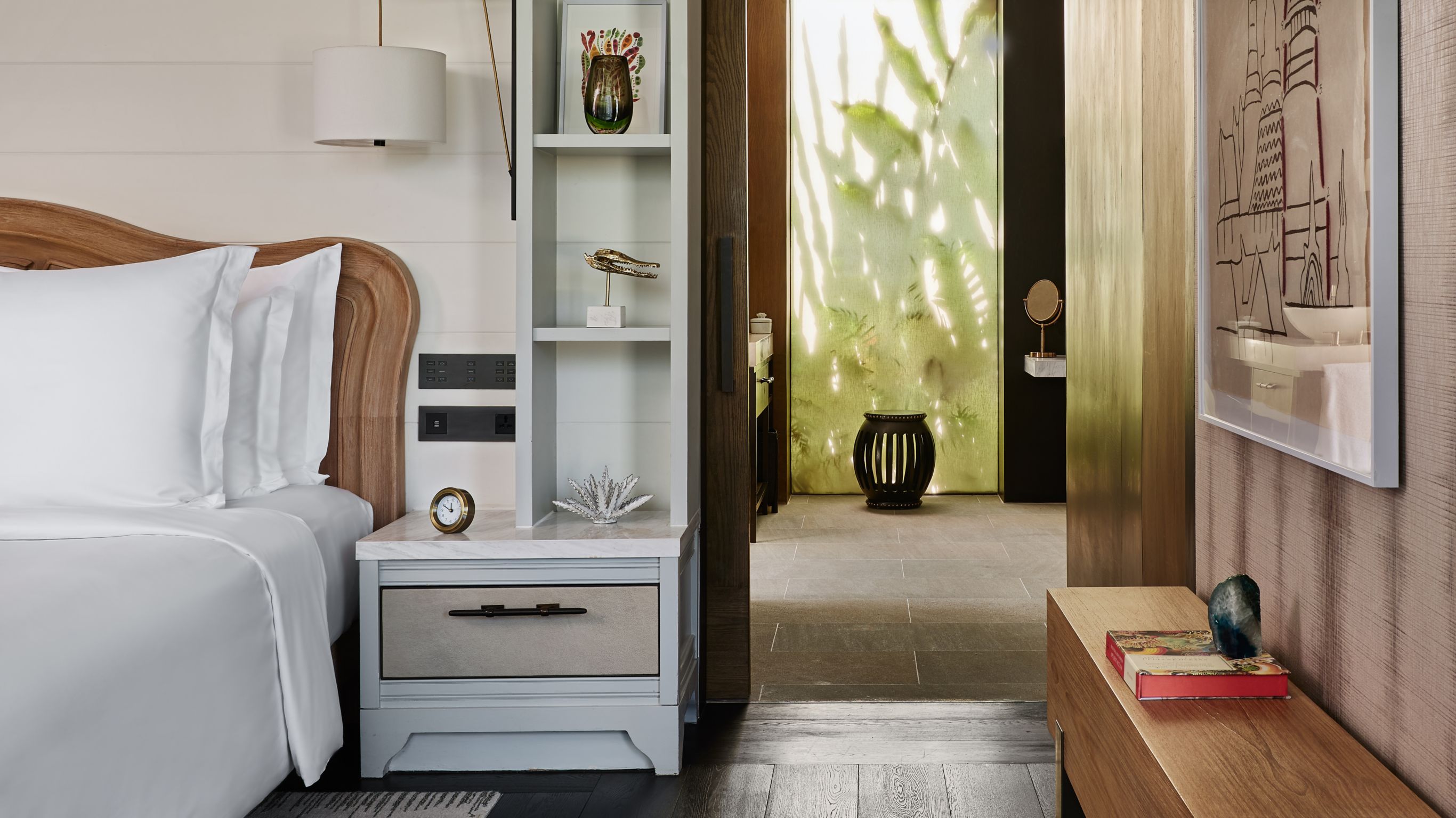 Pavilion Bedroom Phuket Rosewood - A private villa with a bed featuring white linens, white shelves, and decorative acce