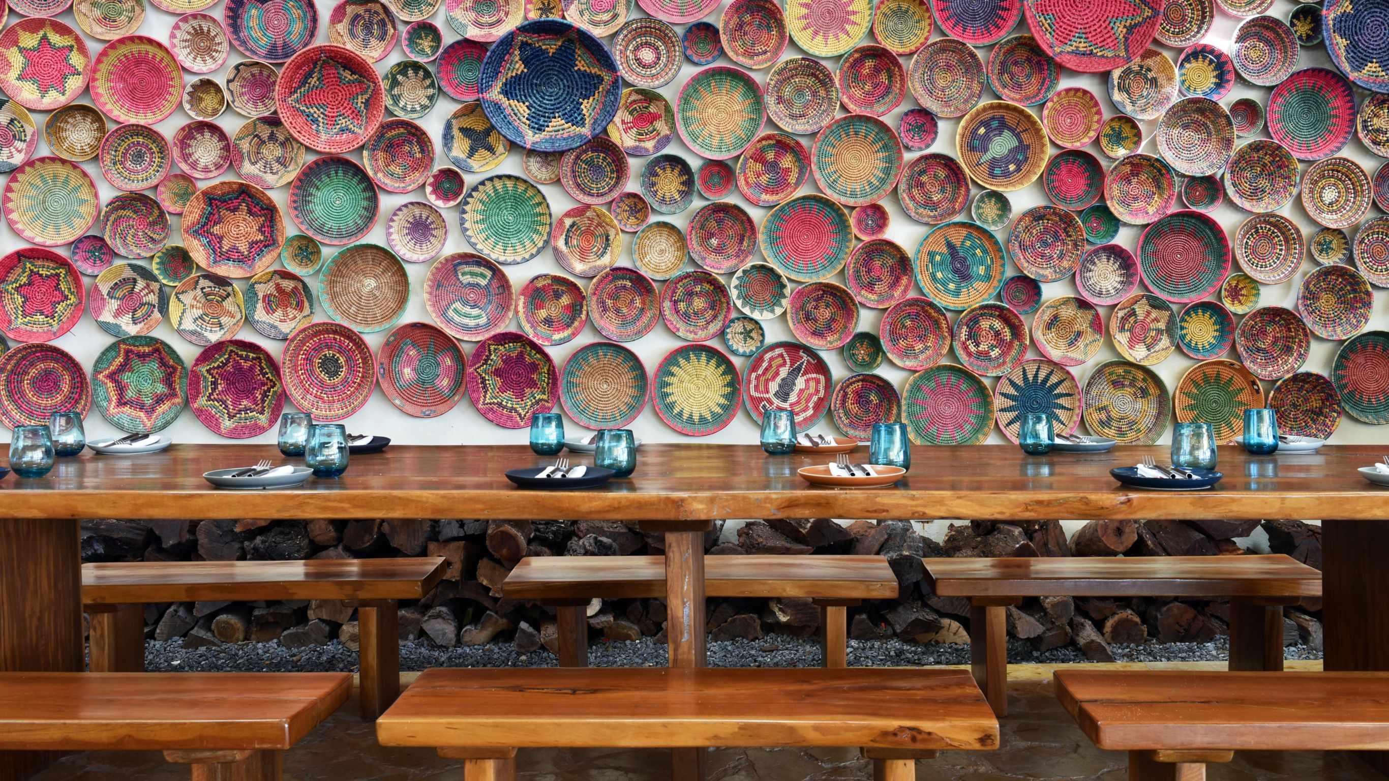 Punta Bonita Restaurant family style table and colorful handwoven baskets decorating wall