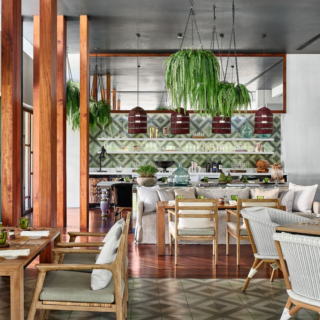 An Italian restaurant at a luxury hotel in Phuket with modern decor and hanging plants.