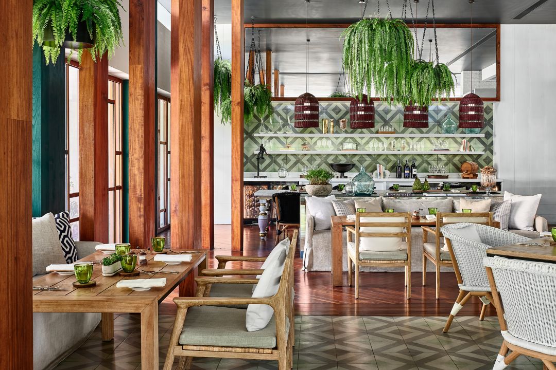An Italian restaurant at a luxury hotel in Phuket with modern decor and hanging plants.