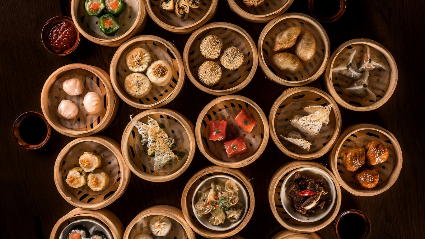 A steaming hot pot filled with an array of fresh ingredients, surrounded by friends and family, celebrating the Mid-Autumn Festival with a delightful brunch