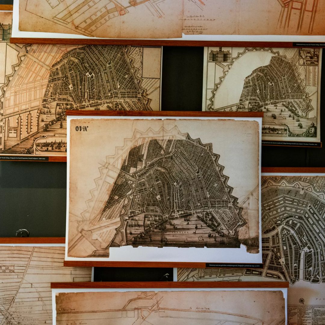 Framed vintage maps of Amsterdam's canals.