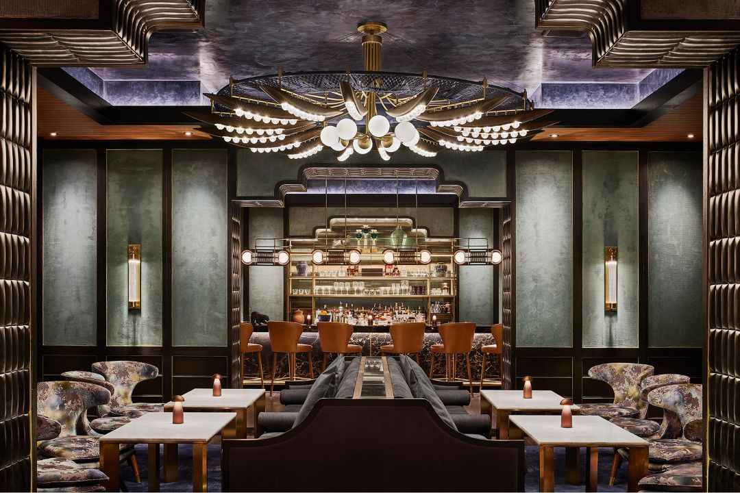 The Nan Bei Chinese restaurant in Bangkok, featuring an ornate chandelier, dining tables, and plush seats.