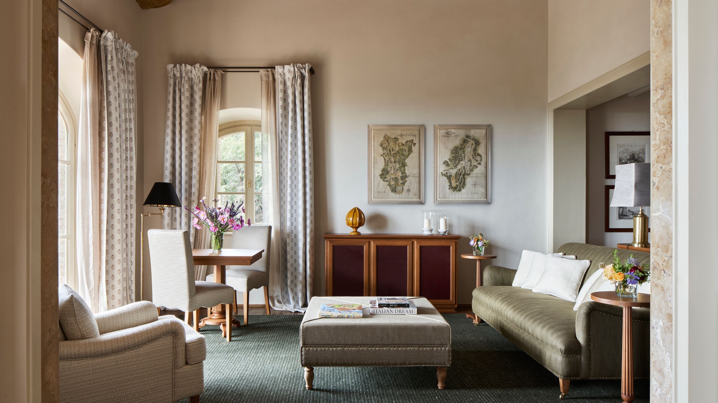 Living room with a sofa, armchair, dining table, and decorative elements