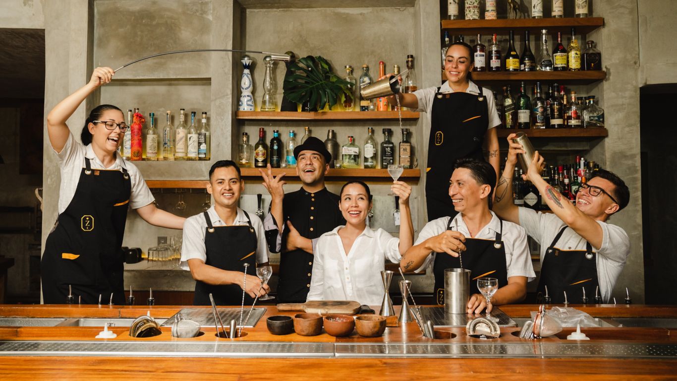 Zapote Bar team cheering and enjoying the preparation of a drink
