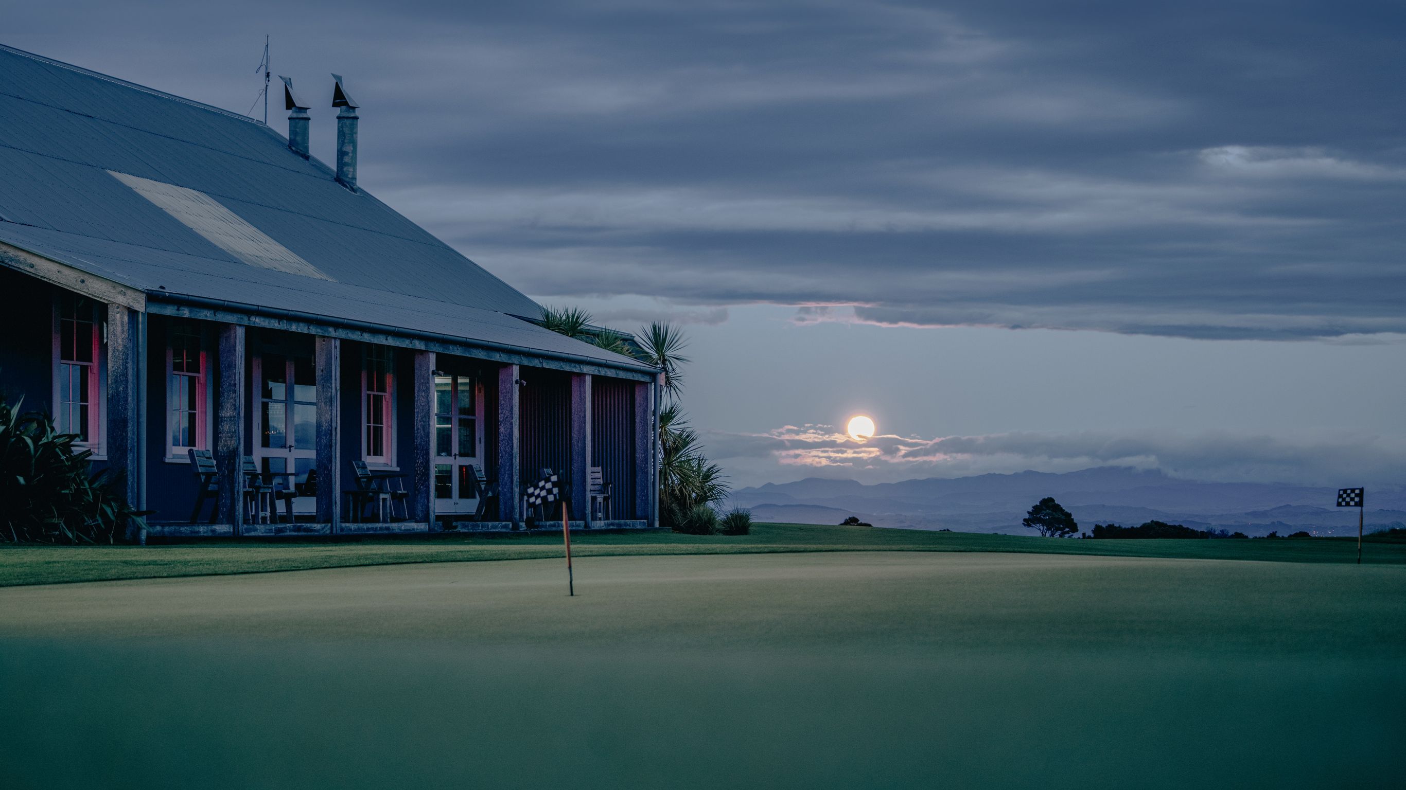 Evening view of the Clubhouse with a full moon rising in the background