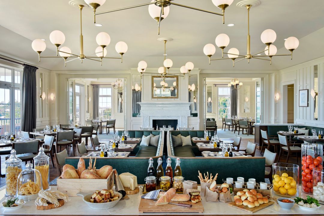 Sul Verde restaurant in Bermuda featuring tables and chairs, and a buffet table with various food items.