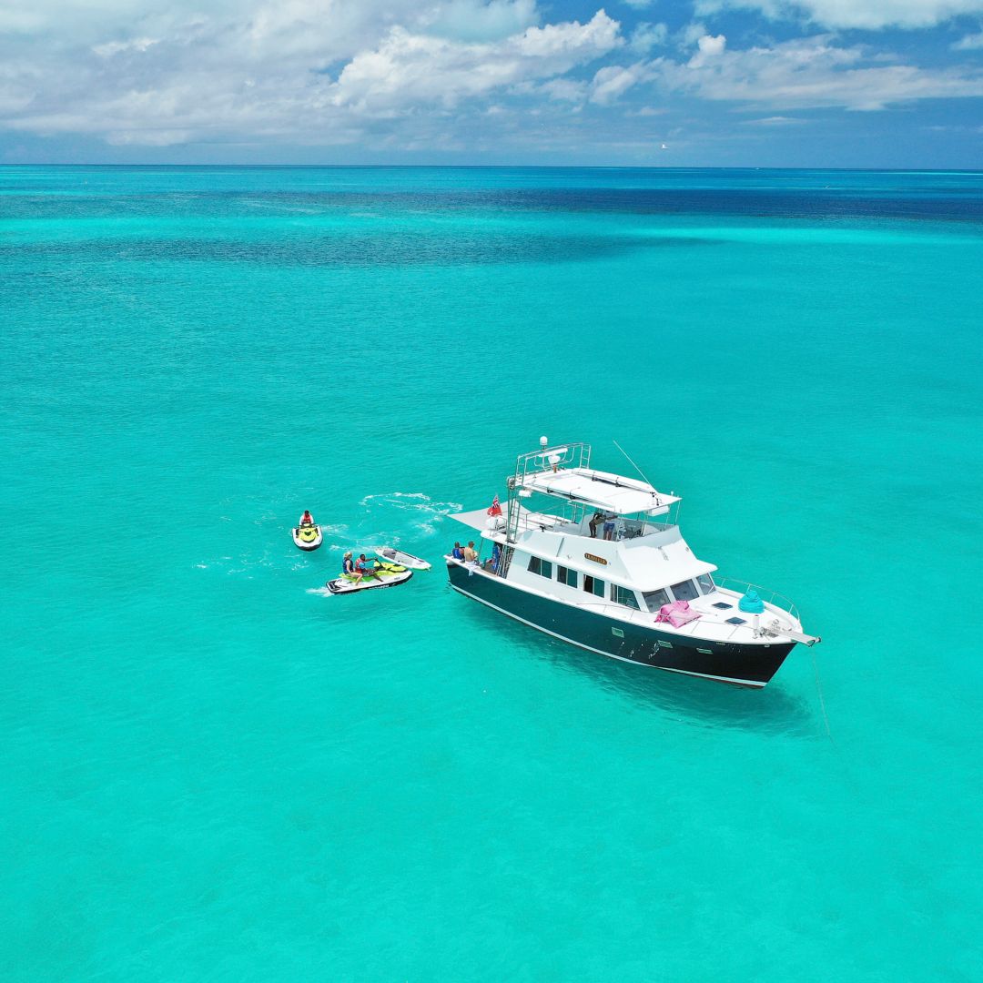 Traveler yacht floating with jet skis