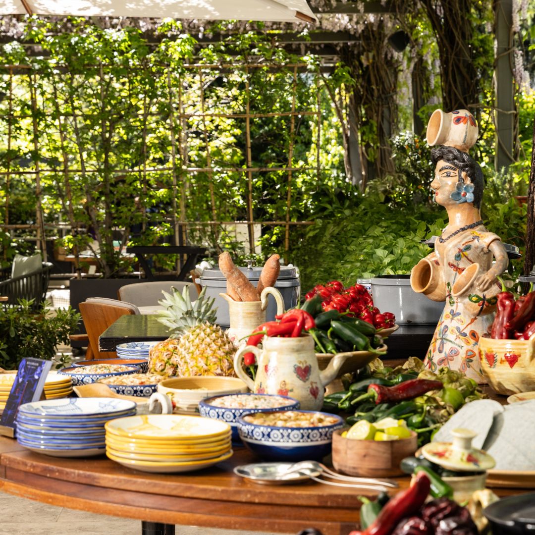 mexican station at a garden terrace with colourful plates and food